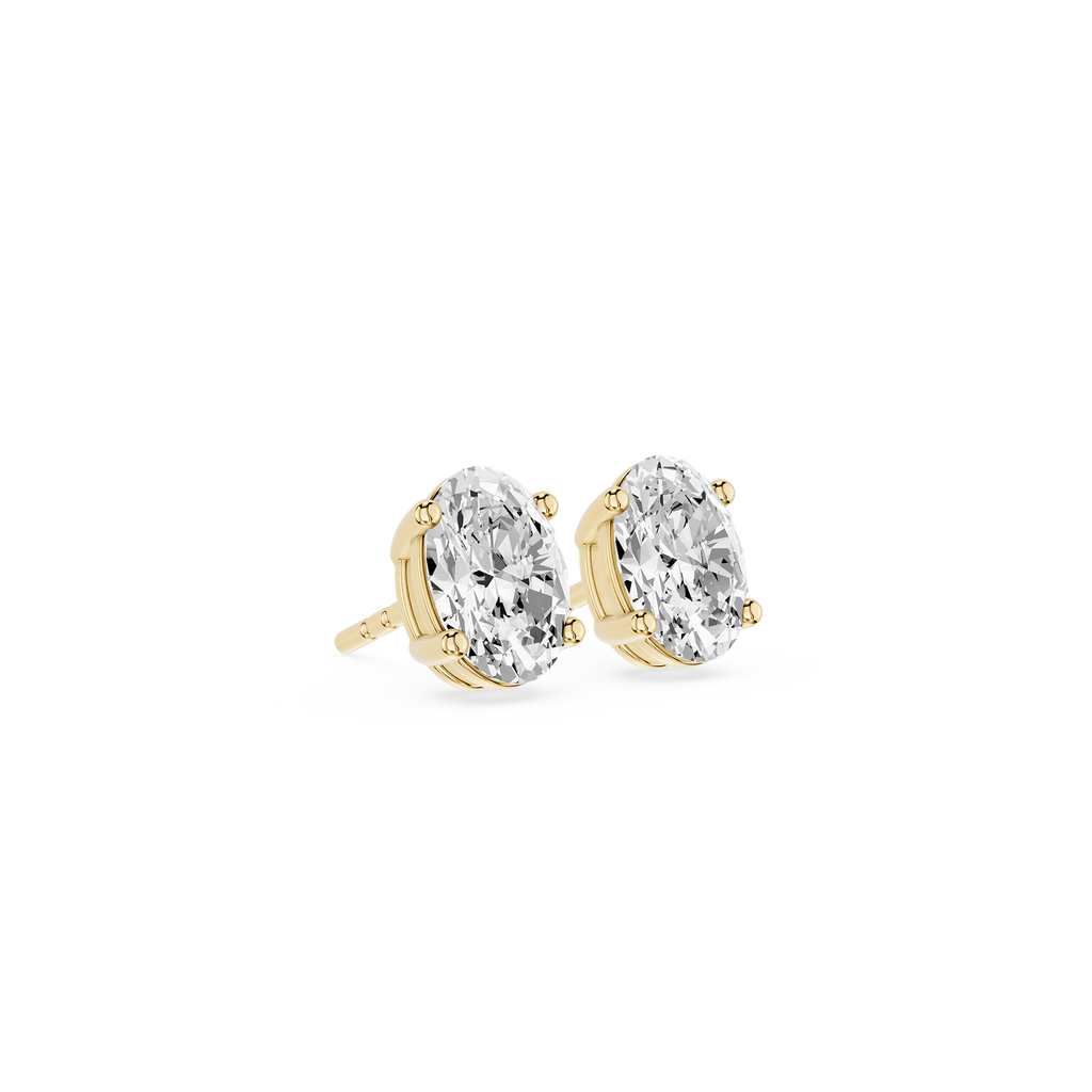 Gold earrings with clear gemstones on a white background