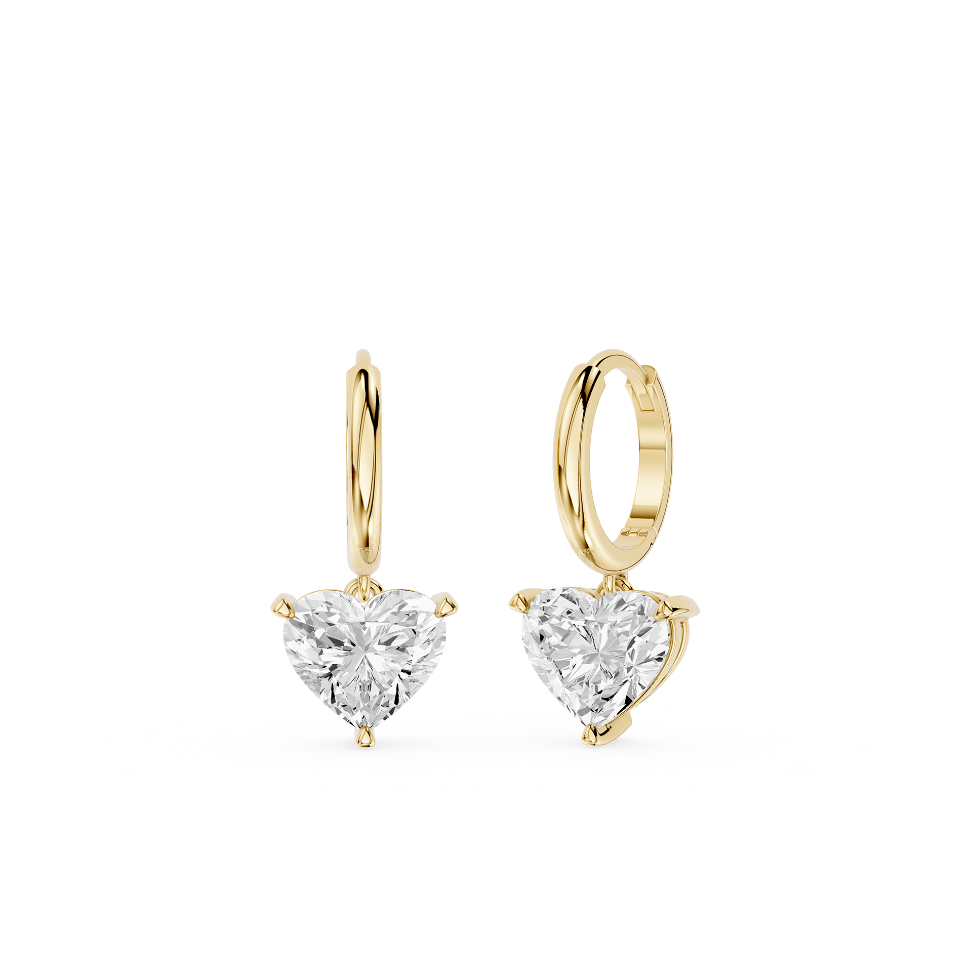 Gold hoop earrings with heart-shaped clear gemstones on a white background