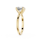 Gold ring with a clear gemstone on a white background