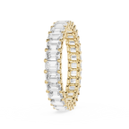 A yellow gold eternity ring featuring a continuous row of baguette-cut clear gemstones on one side and round-cut stones on the other, shown on a plain white background.