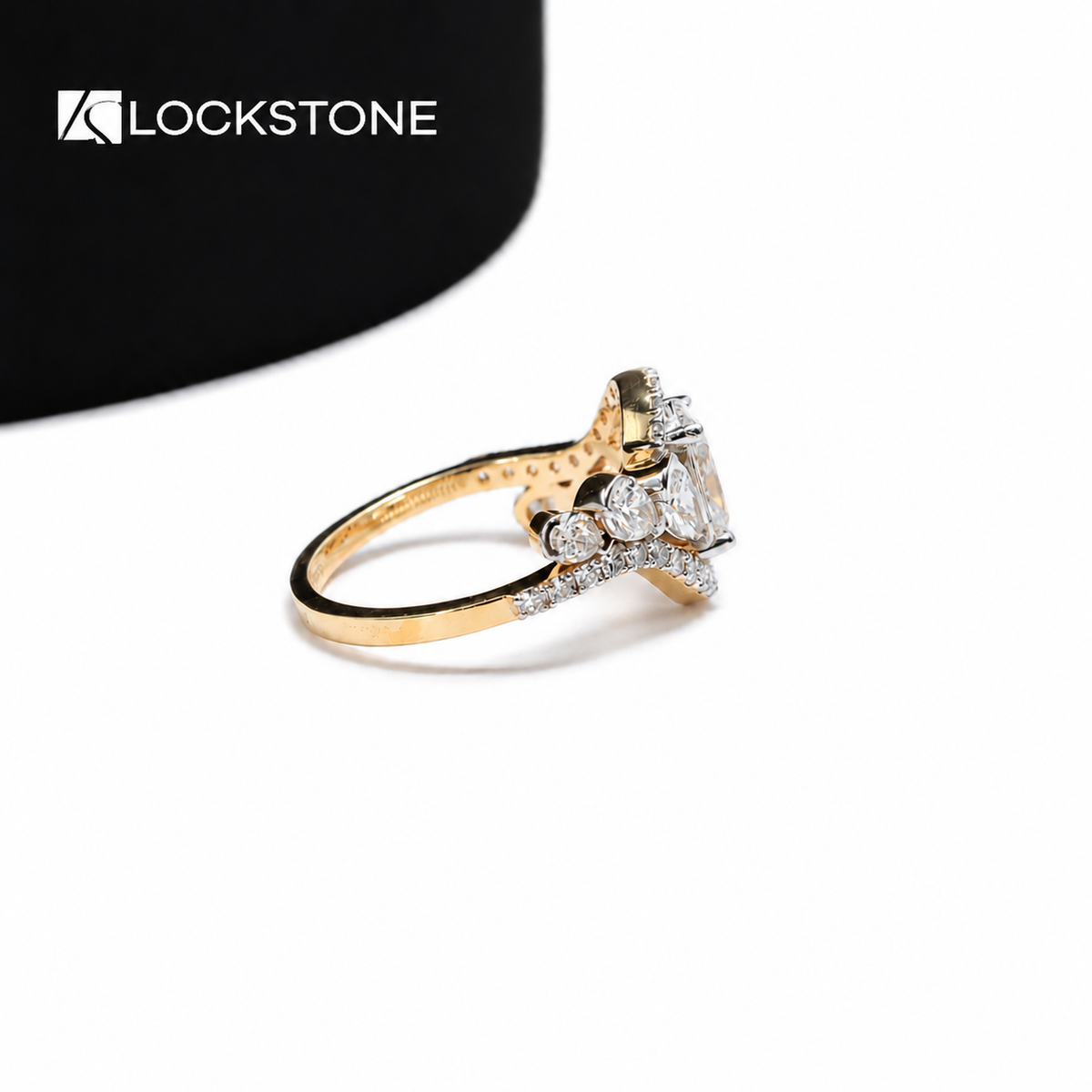 Curved rows of small diamonds frame the oval center stone on this yellow gold engagement ring with prong set side diamonds
