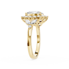 A yellow gold ring with a large round-cut center stone and a surrounding halo of smaller marquise-cut stones, shown on a plain white background.