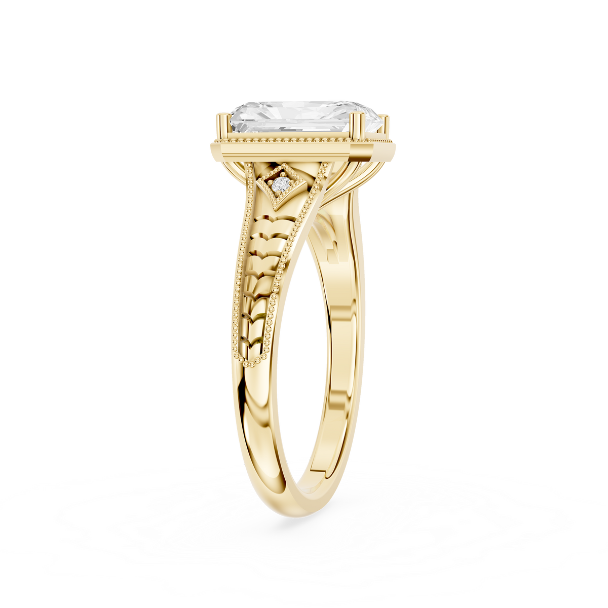 Rectangular radiant diamond ring in yellow gold with geometric openwork shoulders and an antique style beaded setting