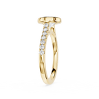A yellow gold ring with a pavé diamond shank, featuring a round bezel-set top and a curved row of clear diamonds on the band, shown against a plain white background.