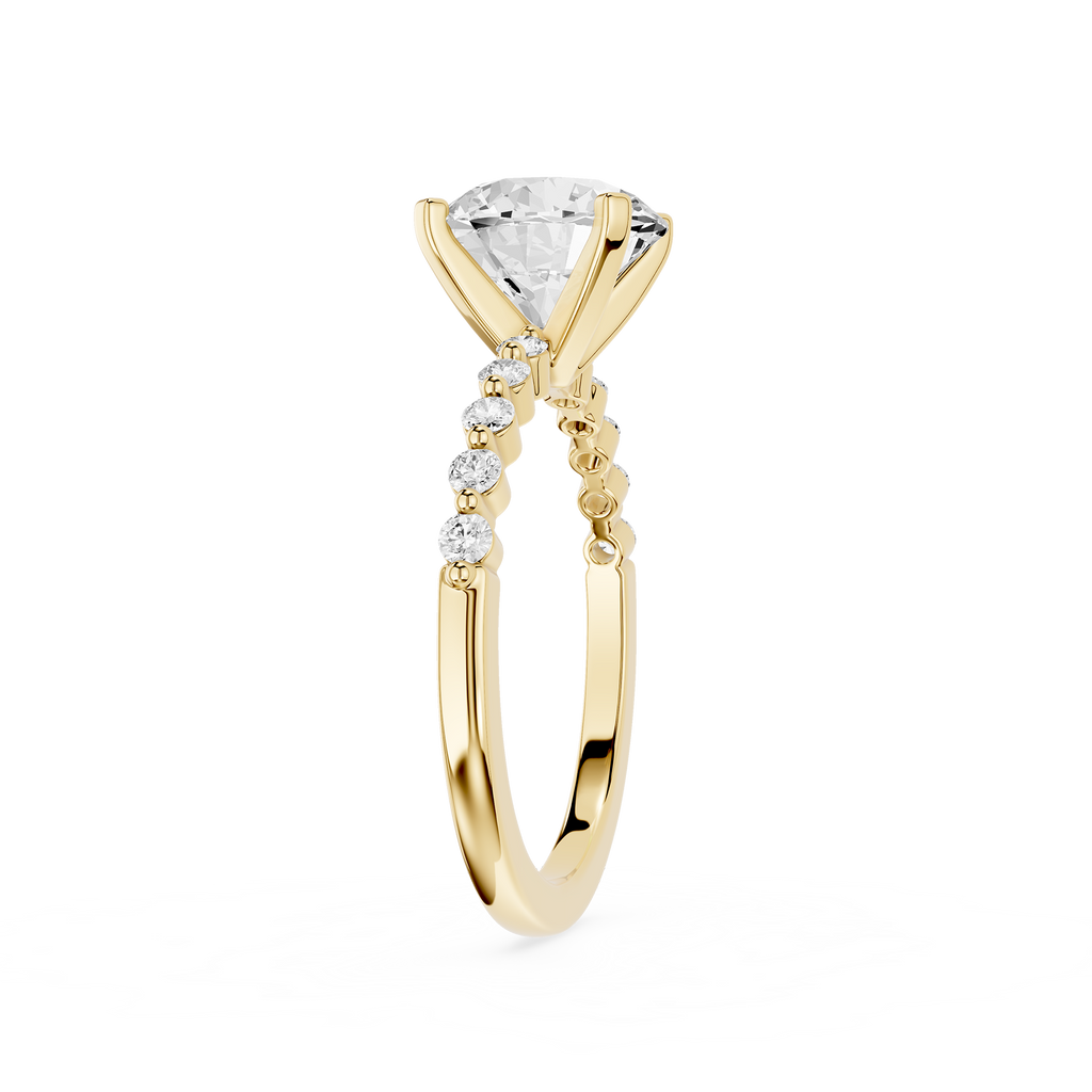 A yellow gold solitaire engagement ring featuring a large round brilliant-cut diamond center stone and a pavé band with small accent diamonds, shown on a plain white background.