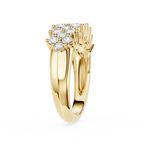 A Yellow-toned split-shank ring with a prominent cluster of round-cut diamonds at the top, shown on a clean white background.