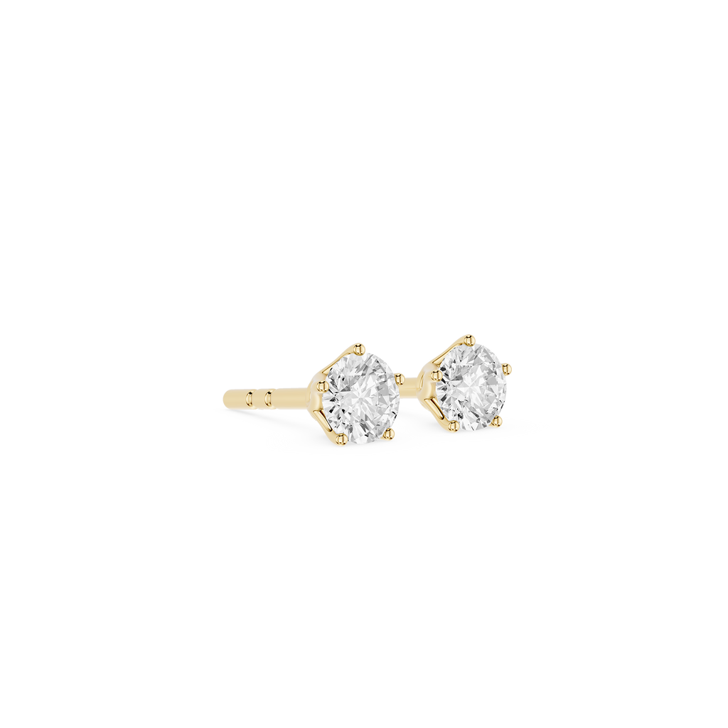 Gold stud earrings with clear gemstones on a white background