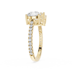 A yellow gold diamond ring with a large round-cut center stone and a pavé band set with small round diamonds, shown on a plain white background.