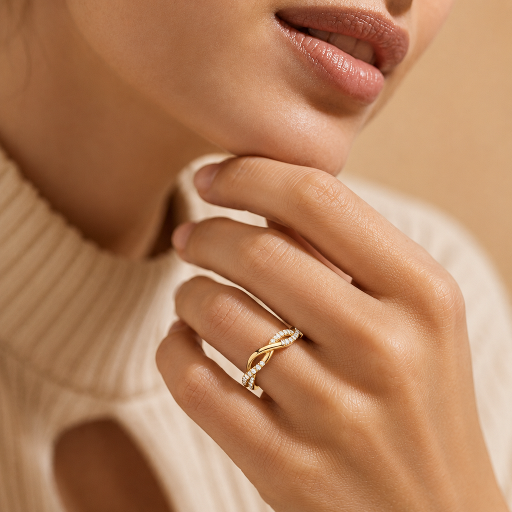 Close-up of a hand wearing a gold ring with a beige background