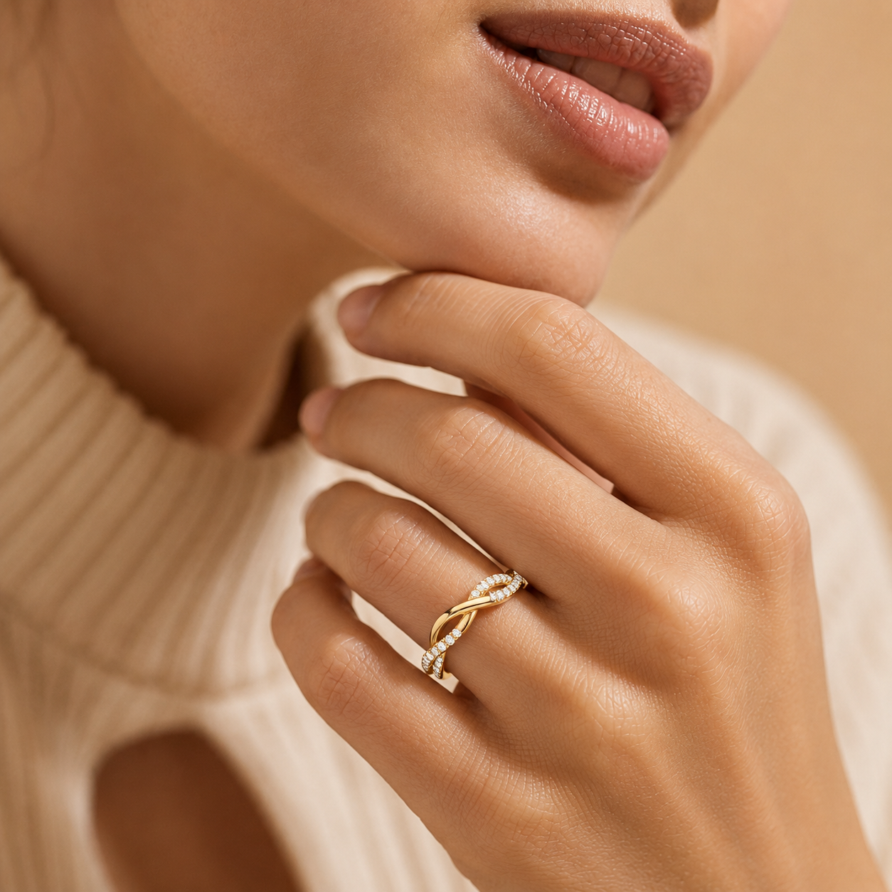 Close-up of a hand wearing a gold ring with a beige background