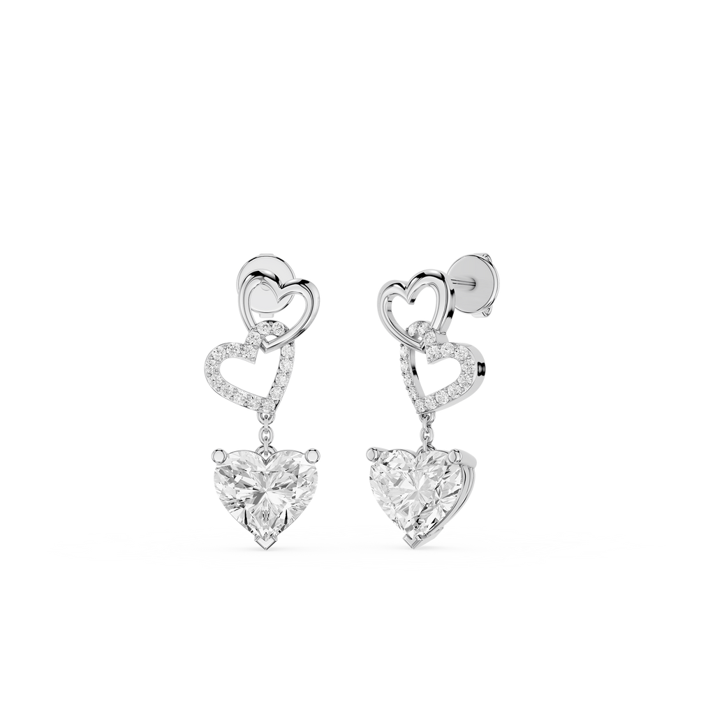 Heart-shaped earrings with clear gemstones on a white background