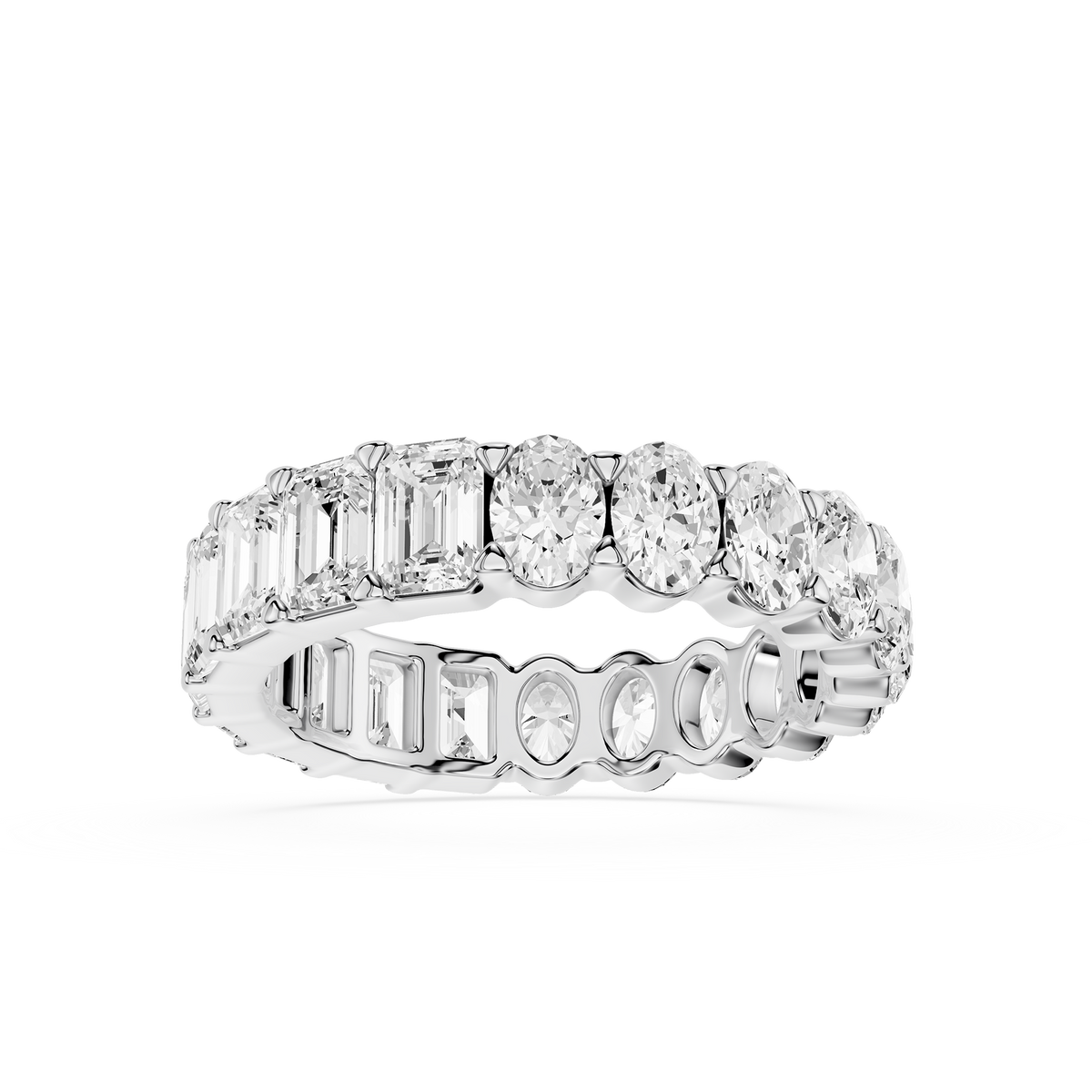 Diamond ring with various cut diamonds on a white backgrouWhite gold eternity ring featuring emerald cut and oval lab created diamonds in a continuous setting, fine jewelry for bridal setsnd