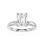 Diamond ring with emerald-cut gemstone on a white background
