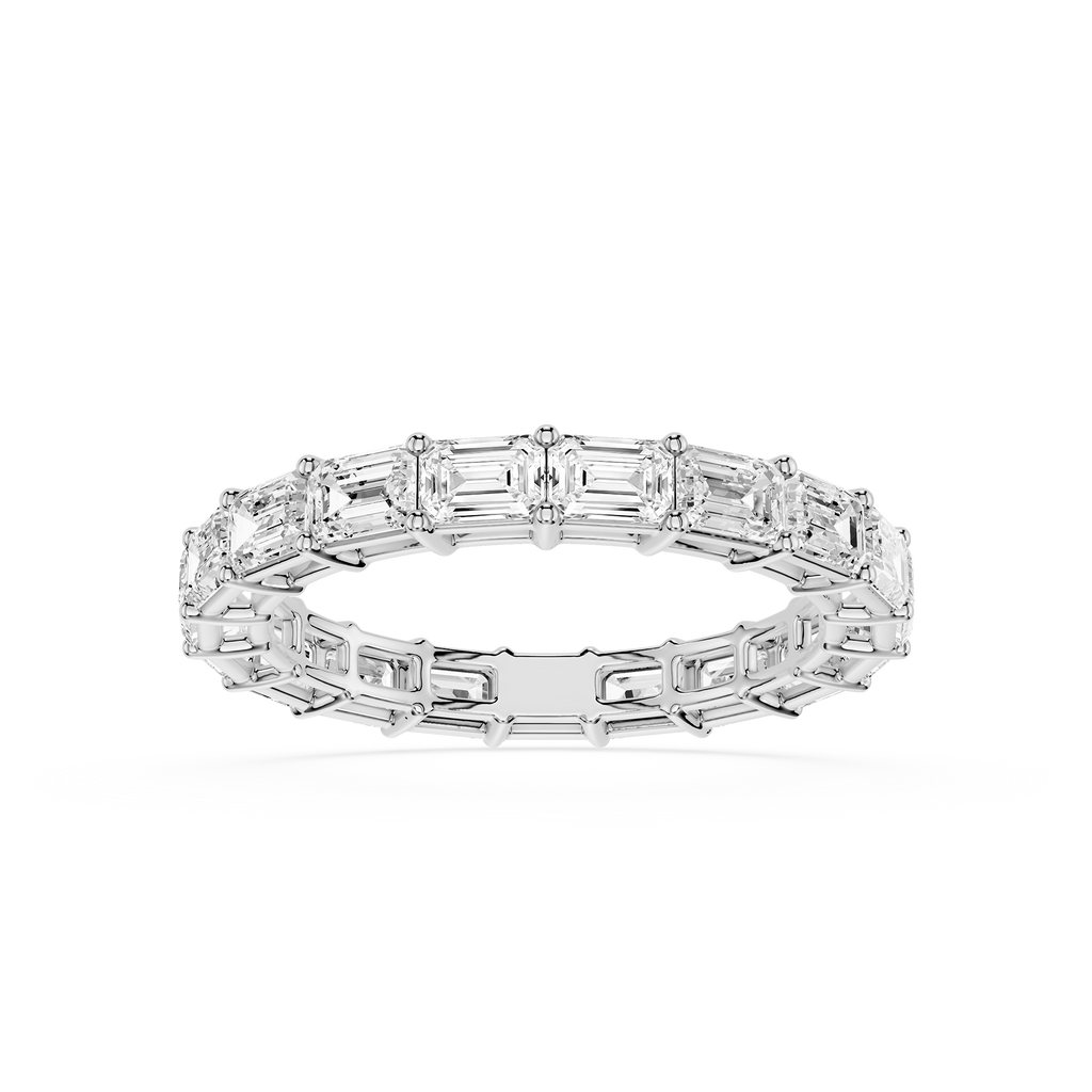 A silver-toned eternity ring featuring a continuous row of baguette-cut clear gemstones, shown on a clean white background.