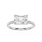 An emerald-cut diamond engagement ring in a silver-colored metal band with pavé-set accent diamonds, shown on a clean white background.