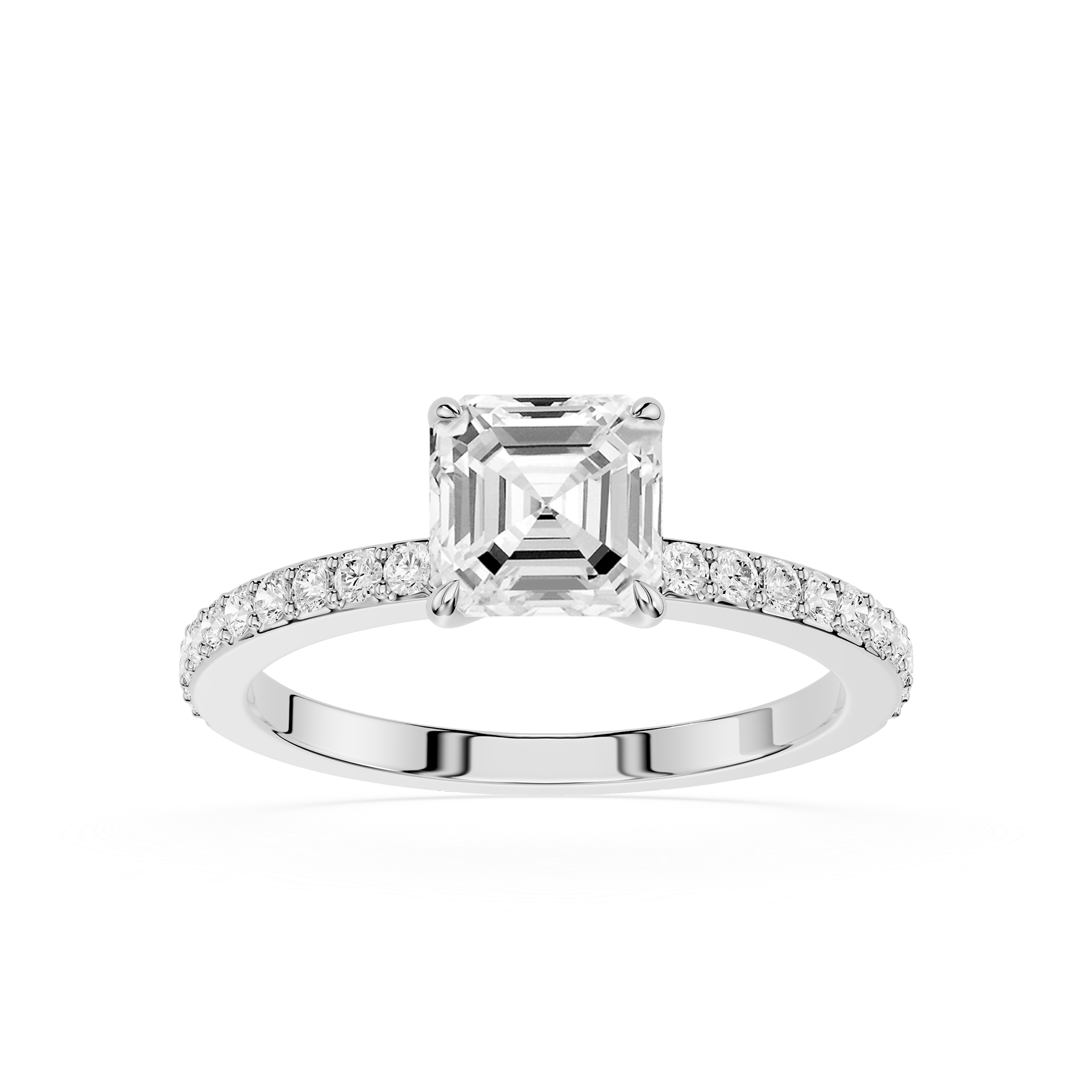 An emerald-cut diamond engagement ring in a silver-colored metal setting, featuring a pavé band with small round diamonds, shot against a solid white background.