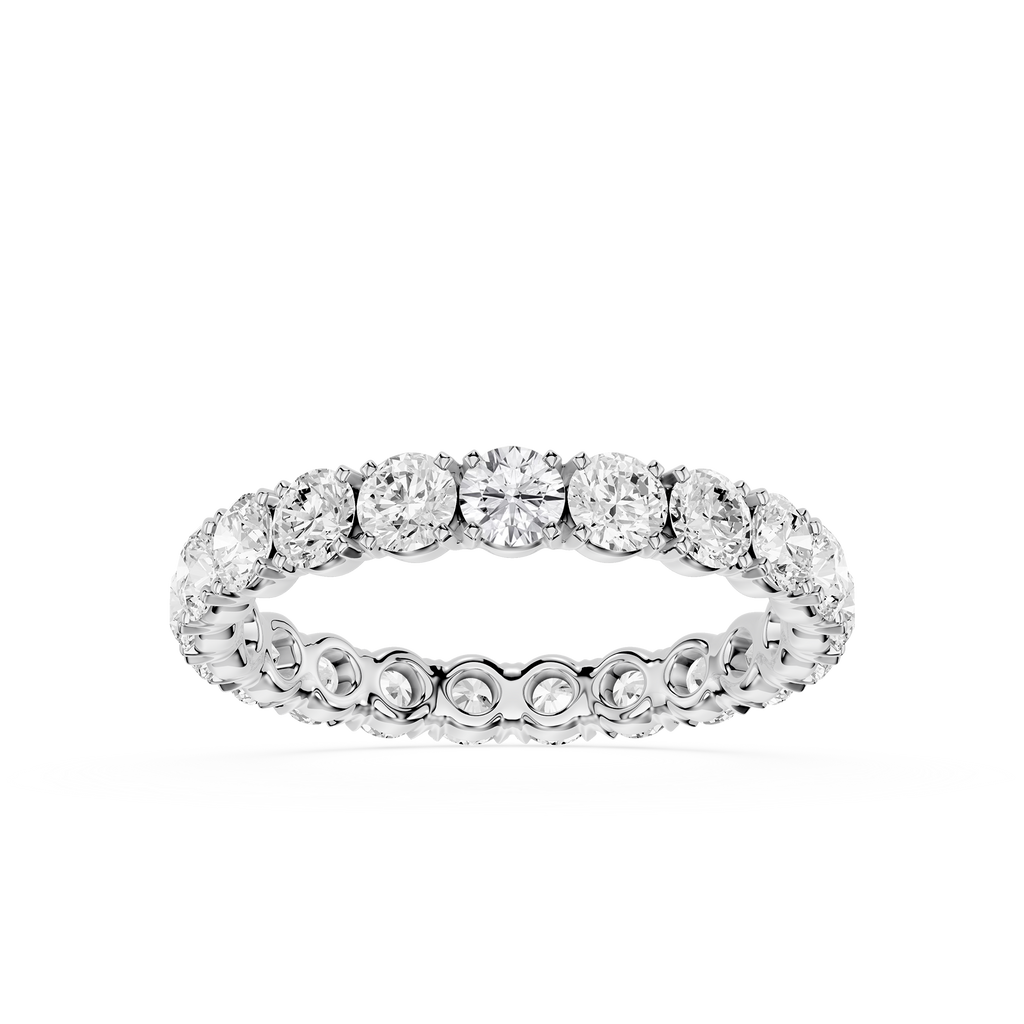 A diamond eternity band ring in a silver-toned setting, shown on a clean white background.