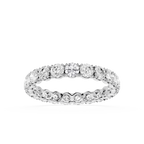 A diamond eternity band ring in a silver-toned setting, shown on a clean white background.