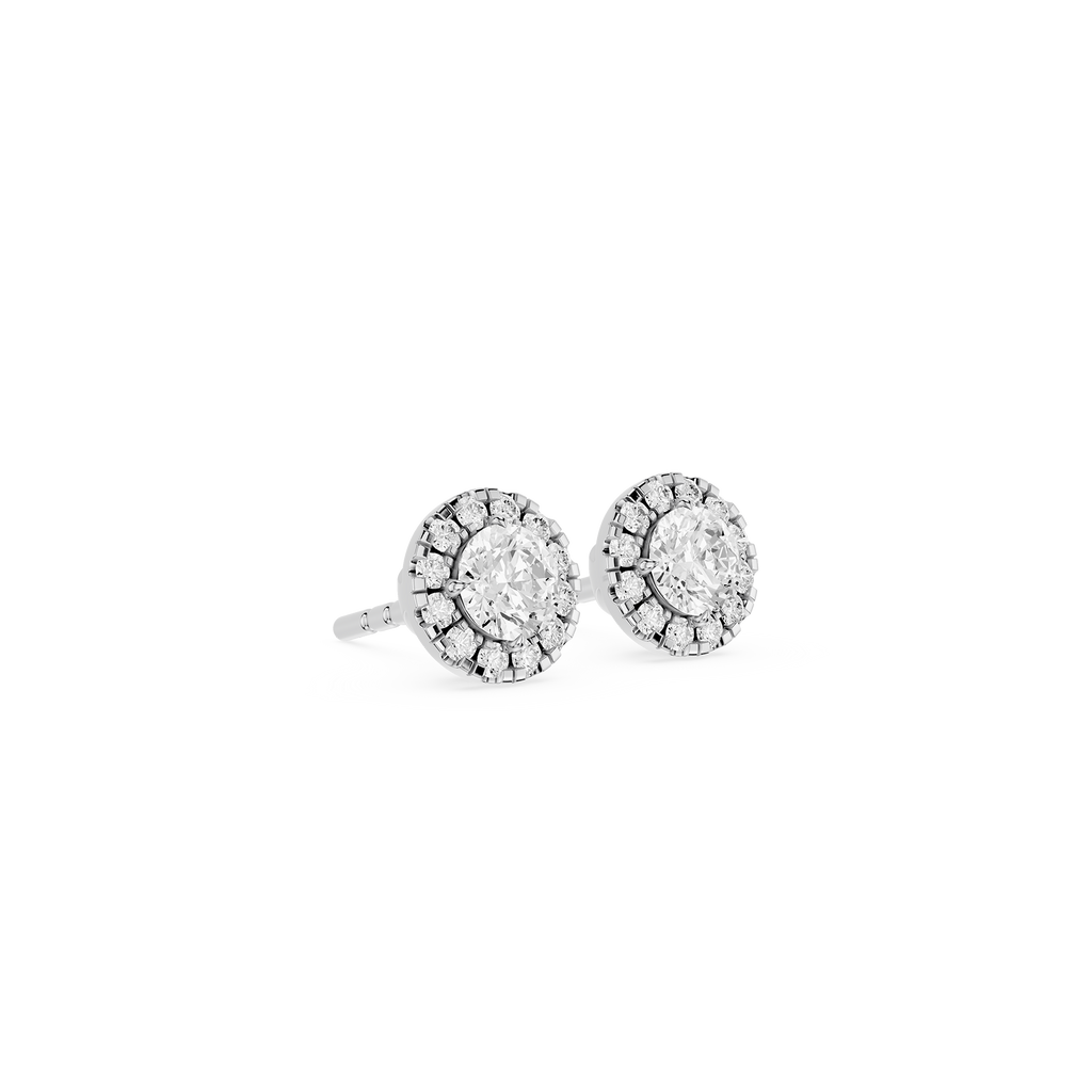 Pair of silver earrings with clear gemstones on a white background