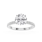 A round-cut diamond engagement ring with a brilliant solitaire center stone and a pavé-set diamond band in a silver-toned metal, shown on a plain white background.