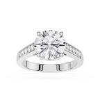 A round-cut diamond solitaire engagement ring with a silver-colored band featuring pavé-set diamonds on the shoulders, shown on a clean white background.