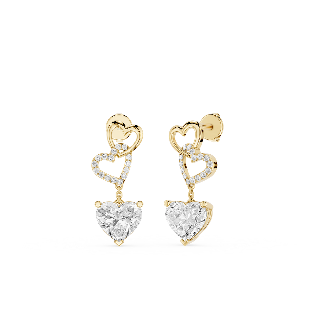 Gold heart-shaped earrings with clear gemstones on a white background