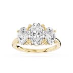 Yellow gold oval cut lab grown diamond three stone engagement ring featuring a larger center diamond and two oval side stones