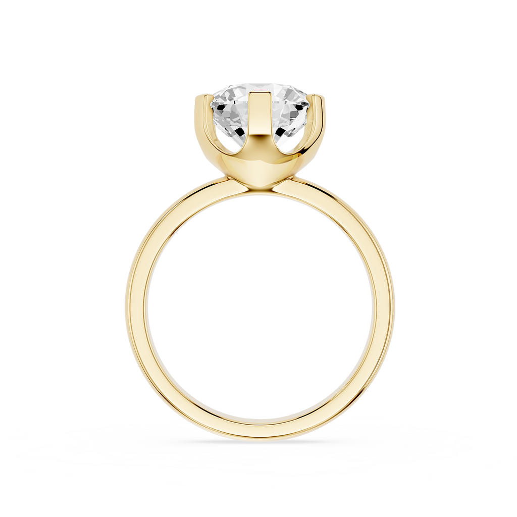 Gold ring with a clear gemstone on a white background