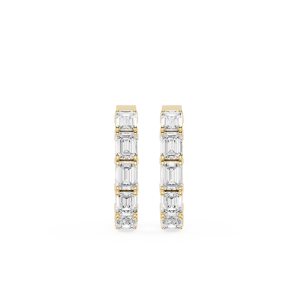 Gold and diamond earrings on a white background