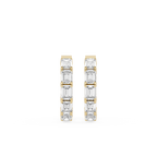 Gold and diamond earrings on a white background