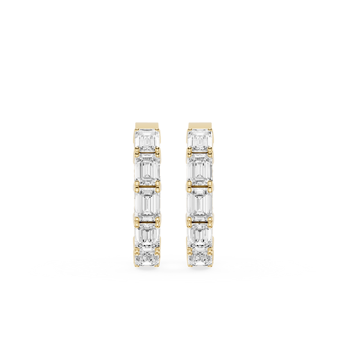 Gold and diamond earrings on a white background