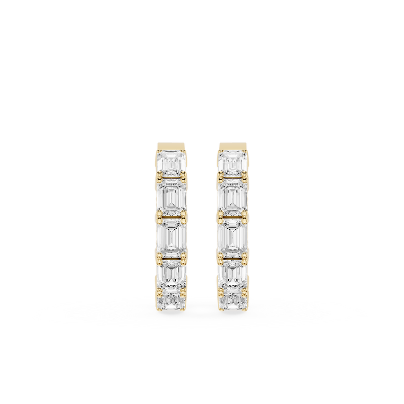 Gold and diamond earrings on a white background