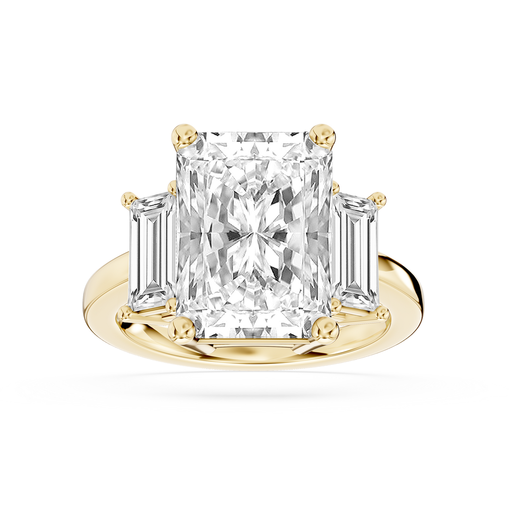 Yellow gold radiant cut lab grown diamond engagement ring featuring tapered baguette side stones and a polished band