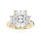 Yellow gold radiant cut lab grown diamond engagement ring featuring tapered baguette side stones and a polished band
