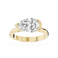 Yellow gold east west pear cut lab grown diamond engagement ring featuring a curved half bezel and polished band
