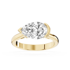 Yellow gold east west pear cut lab grown diamond engagement ring featuring a curved half bezel and polished band