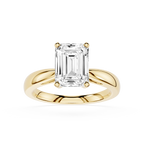 Gold ring with a large emerald-cut diamond on a white background
