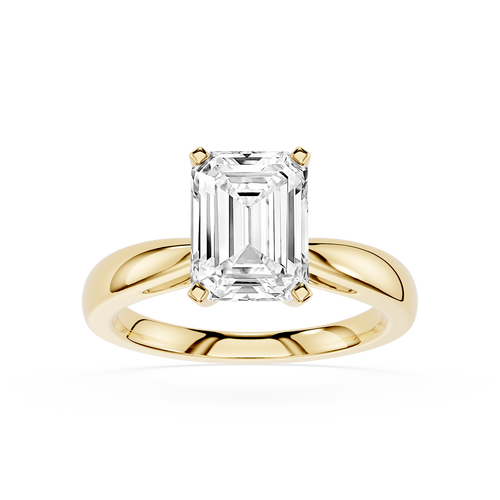 Gold ring with a large emerald-cut diamond on a white background