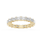 A Yellow gold eternity ring featuring a continuous line of baguette-cut clear gemstones, shown on a clean white background.