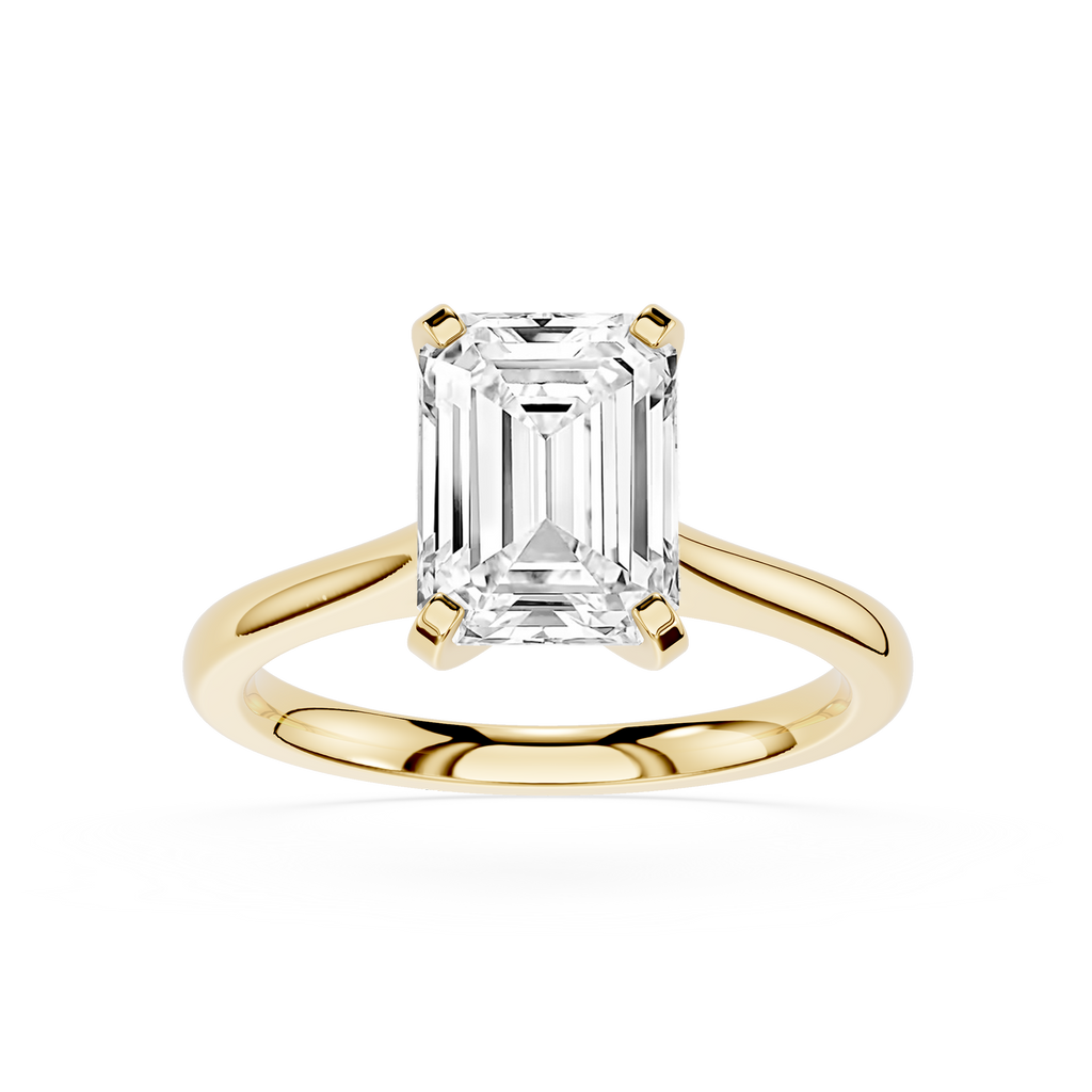 Gold ring with a large emerald-cut diamond on a white background