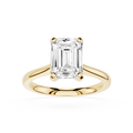 Gold ring with a large emerald-cut diamond on a white background