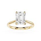 Gold ring with a large emerald-cut diamond on a white background