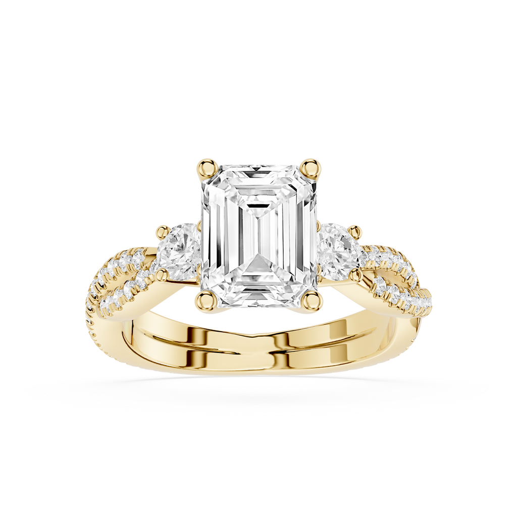 Gold ring with a large emerald-cut diamond and smaller diamonds on a white background