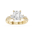 Gold ring with a large emerald-cut diamond and smaller diamonds on a white background