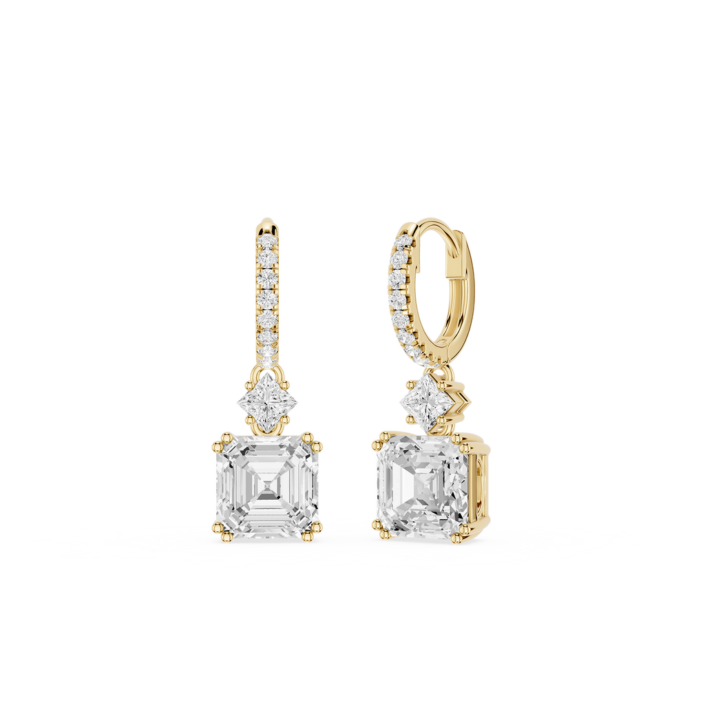 Gold and diamond earrings on a white background