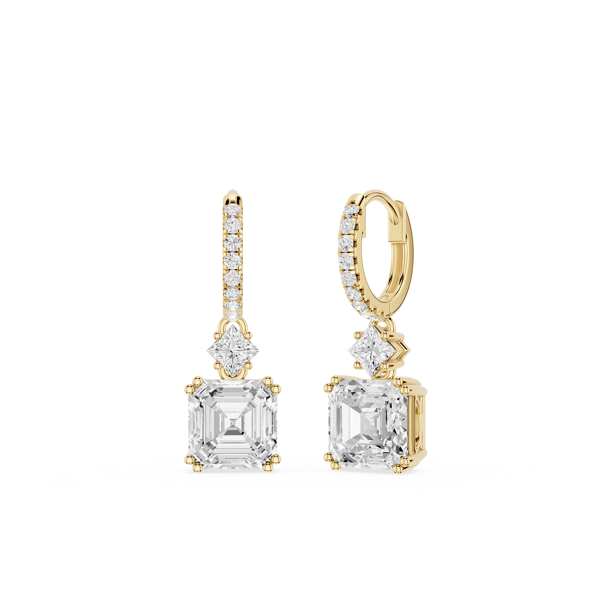 Gold and diamond earrings on a white background