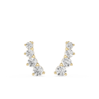 Gold and silver earrings on a white background