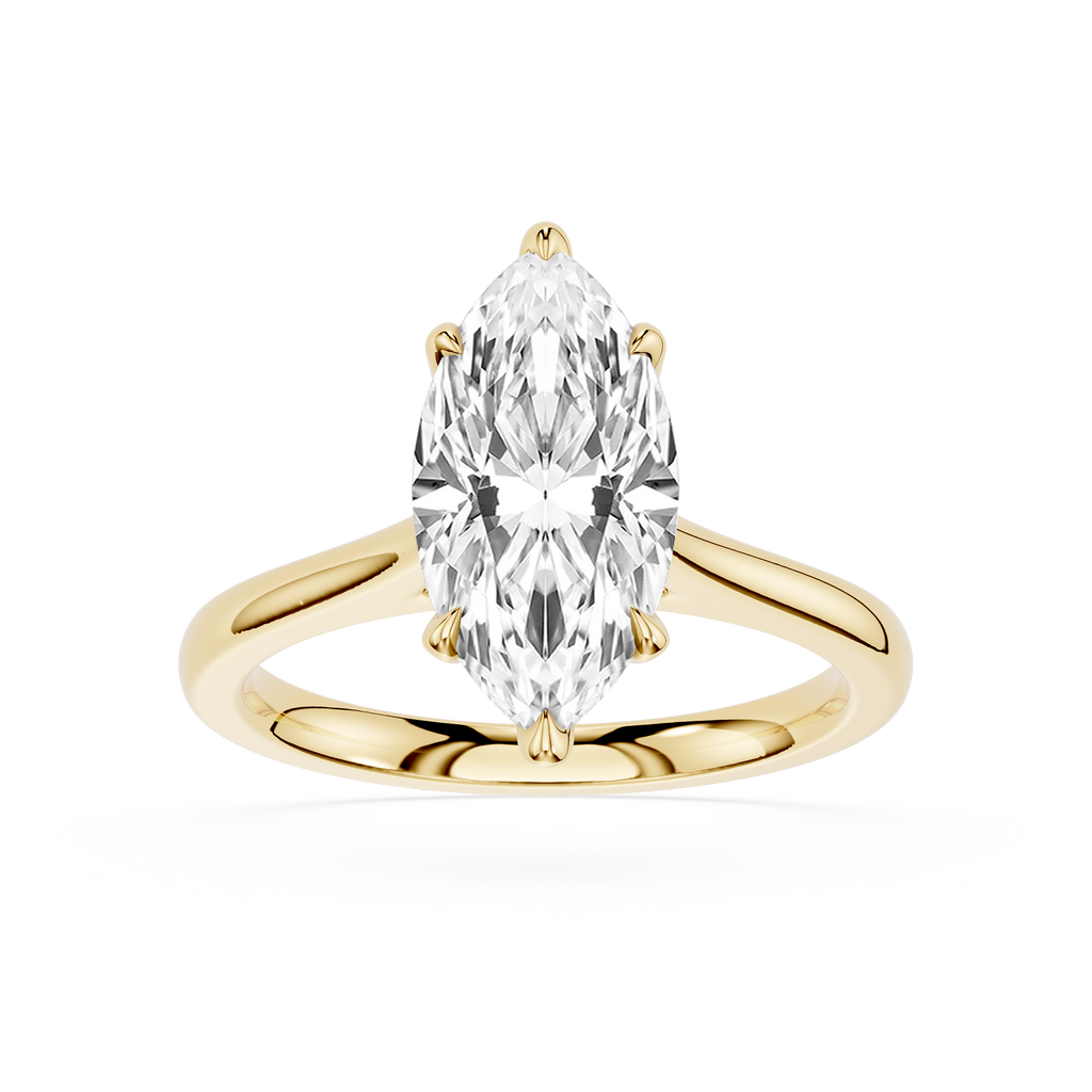 Gold ring with a pear-shaped diamond on a white background