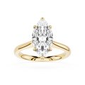 Gold ring with a pear-shaped diamond on a white background