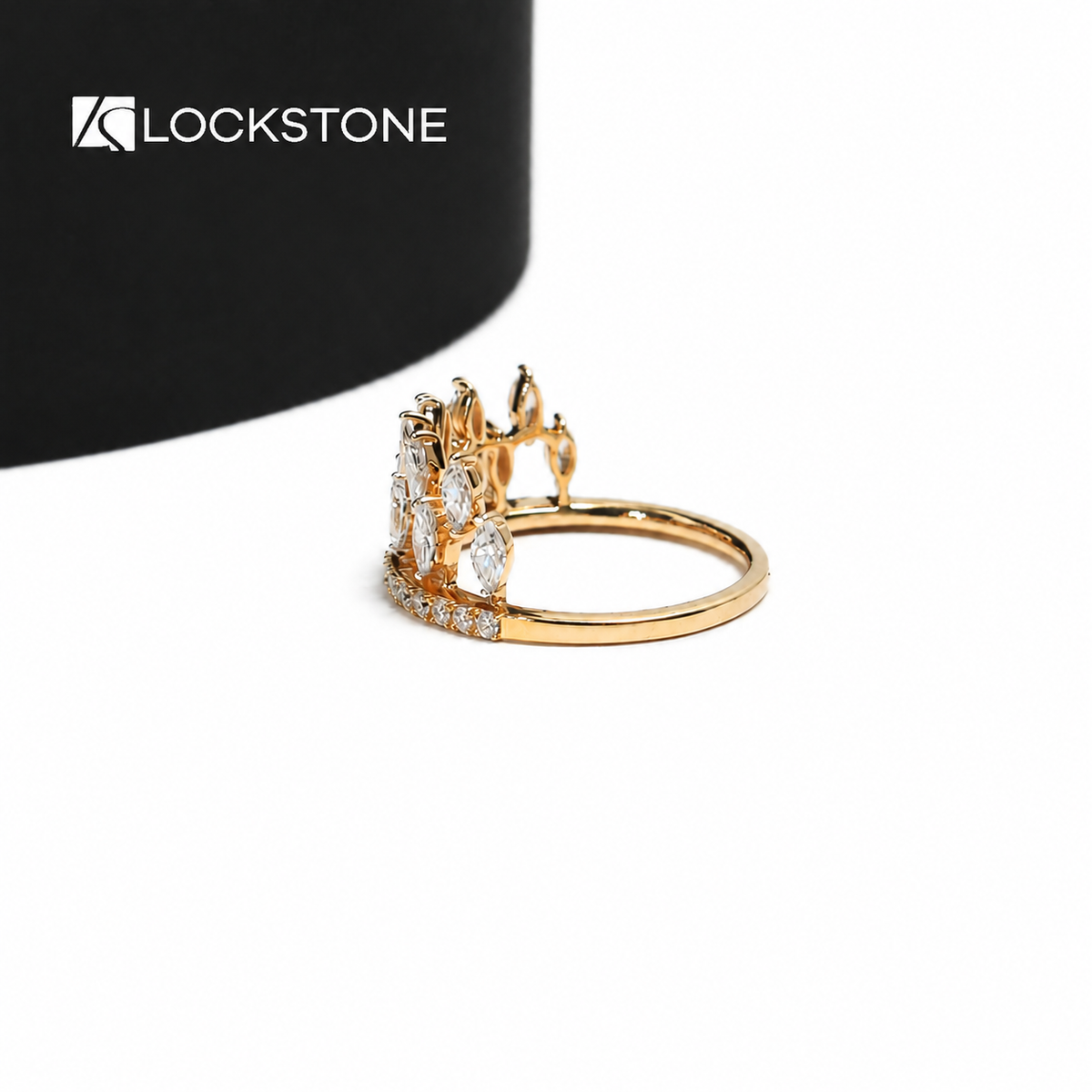 A crown inspired lab grown diamond ring in yellow gold showcasing staggered marquise stones above a curved pavé band